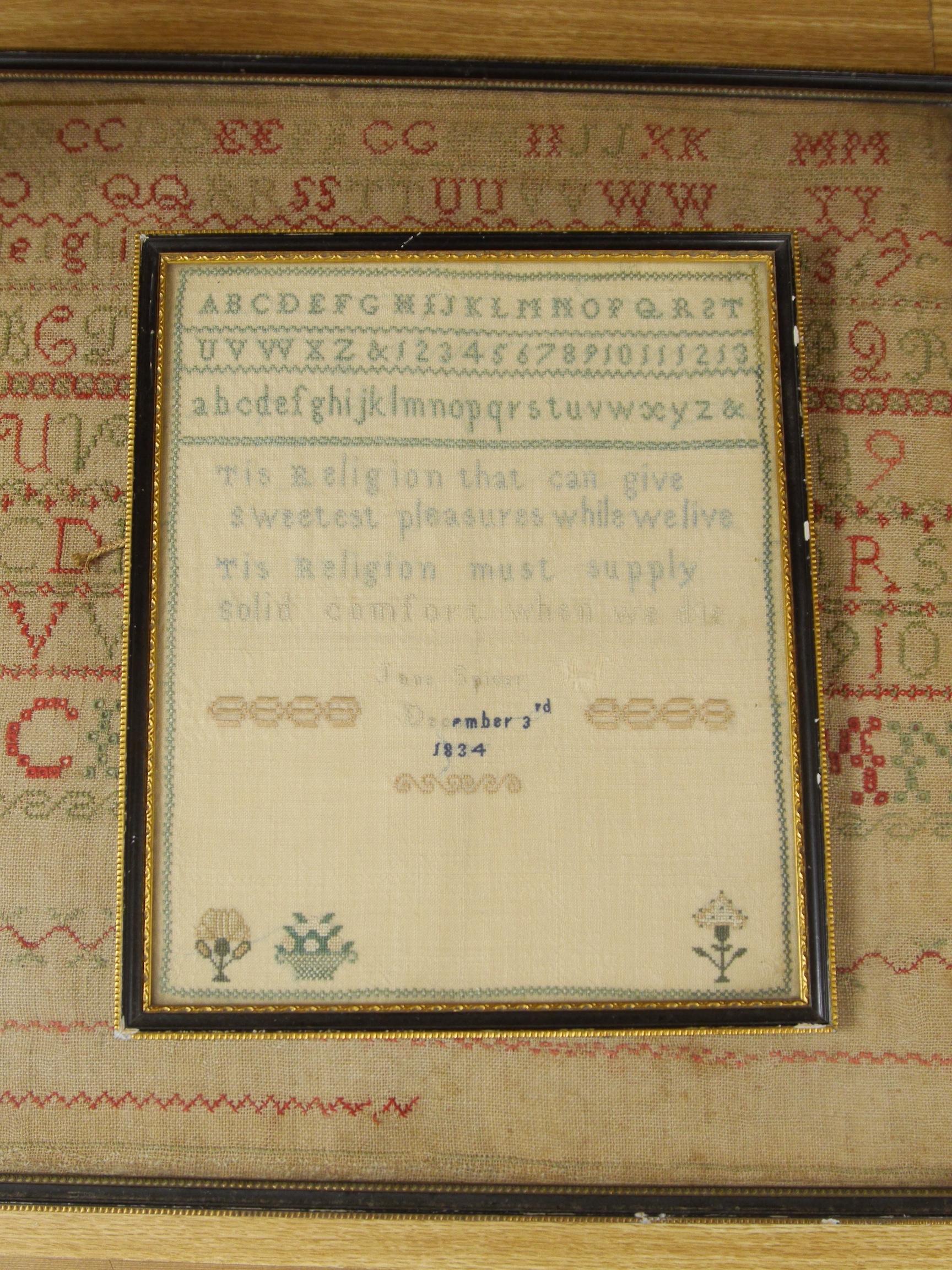 Three framed early to mid 19th century samplers, including an 1828 Adam and Eve sampler embroidered by Emma Parker, worked with a floral border with various spot motifs and verse, together with an alphabet sampler by Jan